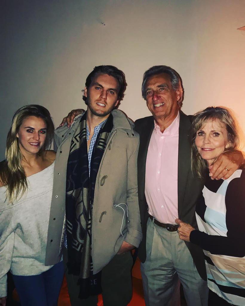 Olivia Flowers, Conner Flowers and their parents posing together 